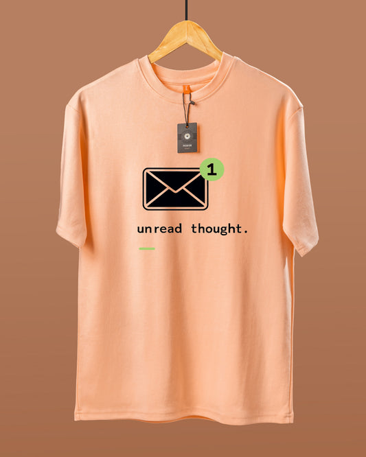 DUMM Unread Thought oversized t-shirt in peach on wooden hanger
