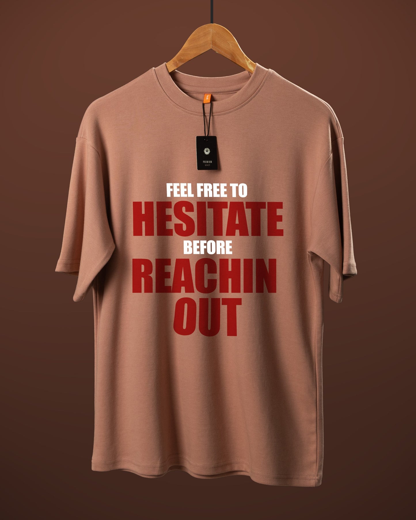 DUMM Feel Free To Hesitate Before Reachin Out oversized t-shirt in dusty rose on wooden hanger