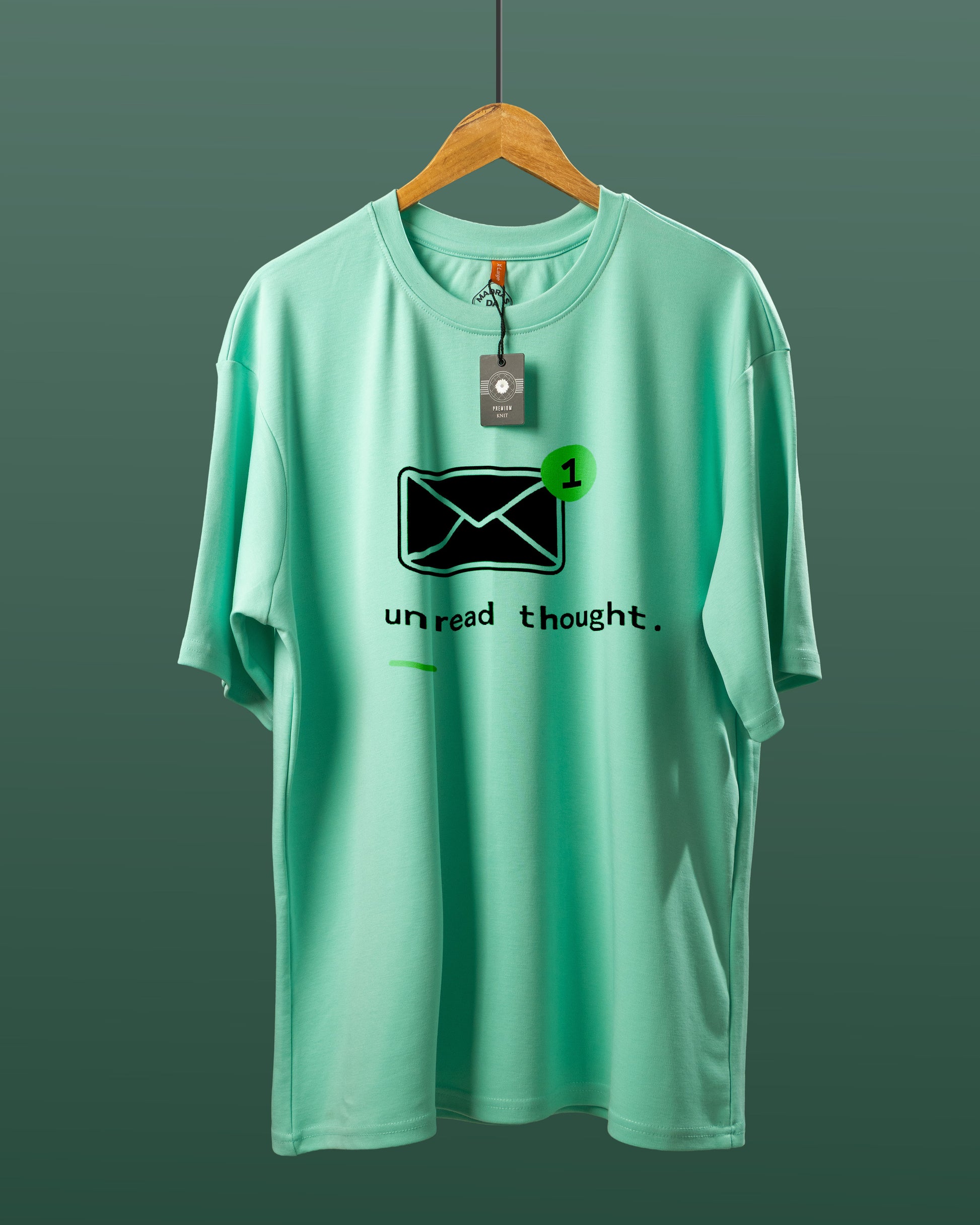 DUMM Unread Thought oversized t-shirt in mint green on wooden hanger