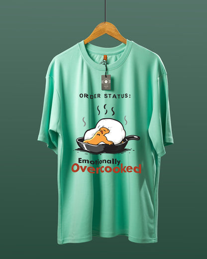 DUMM Emotionally Overcooked oversized t-shirt in mint green on wooden hanger