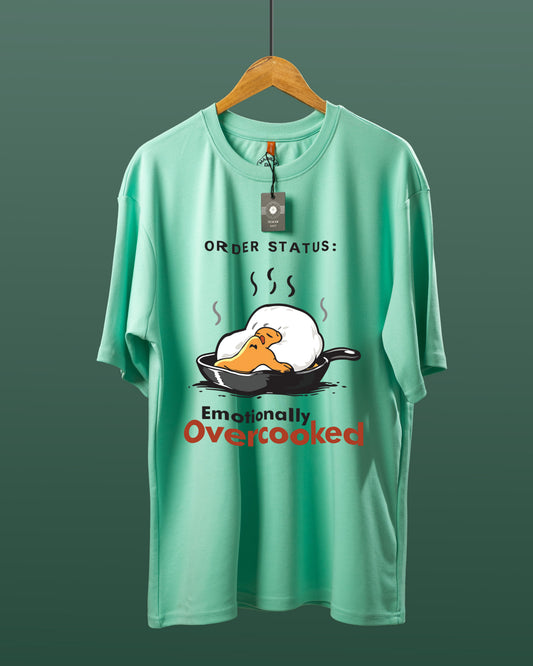 DUMM Emotionally Overcooked oversized t-shirt in mint green on wooden hanger