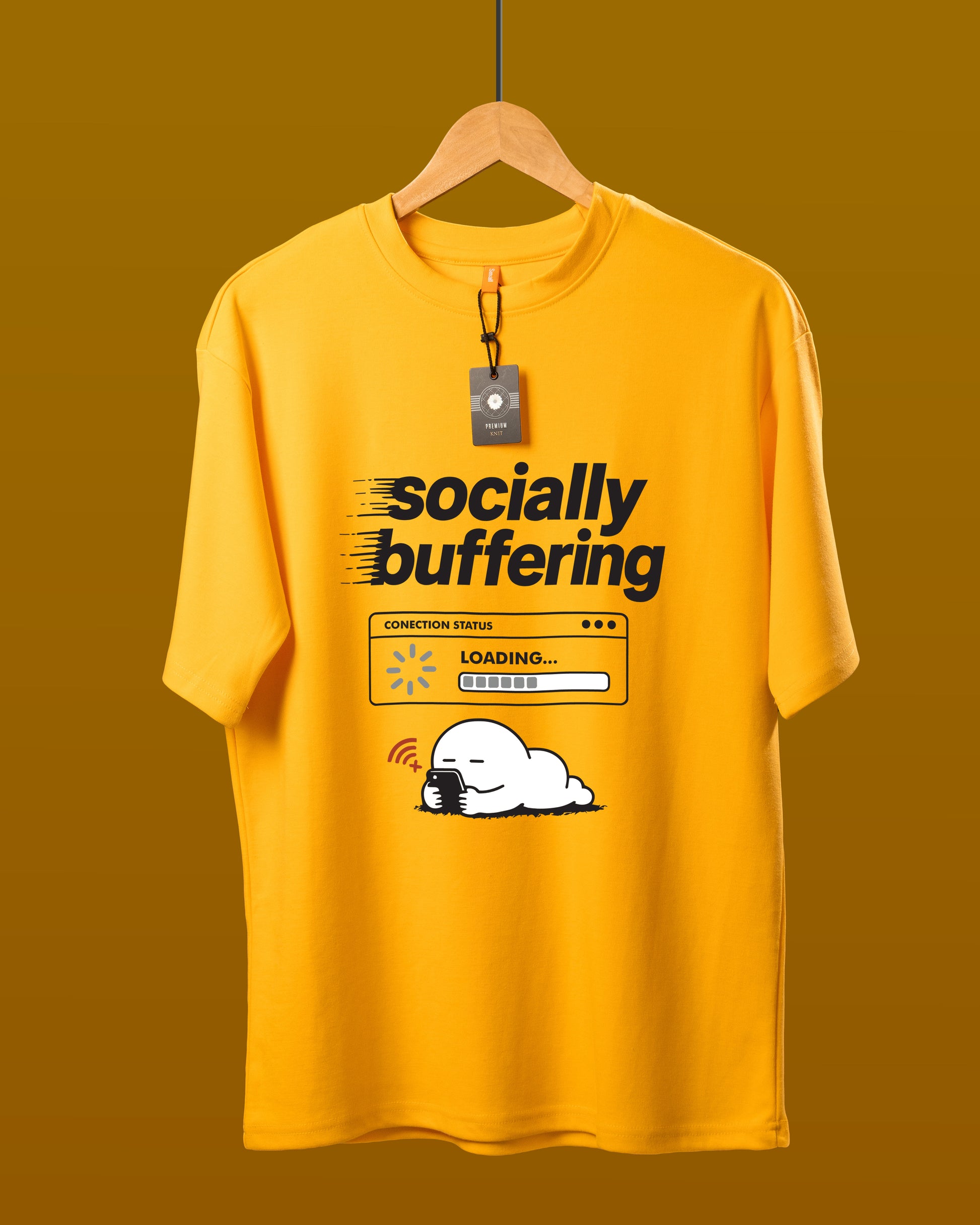 DUMM Socially Buffering oversized t-shirt in mustard yellow on wooden hanger
