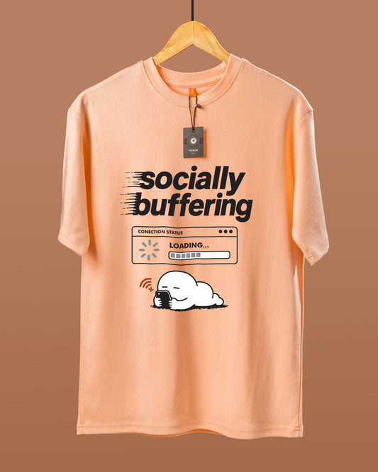 DUMM Socially Buffering oversized t-shirt in peach on wooden hanger
