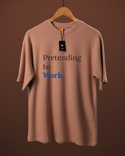 DUMM Pretending To Work oversized t-shirt in dusty rose on wooden hanger