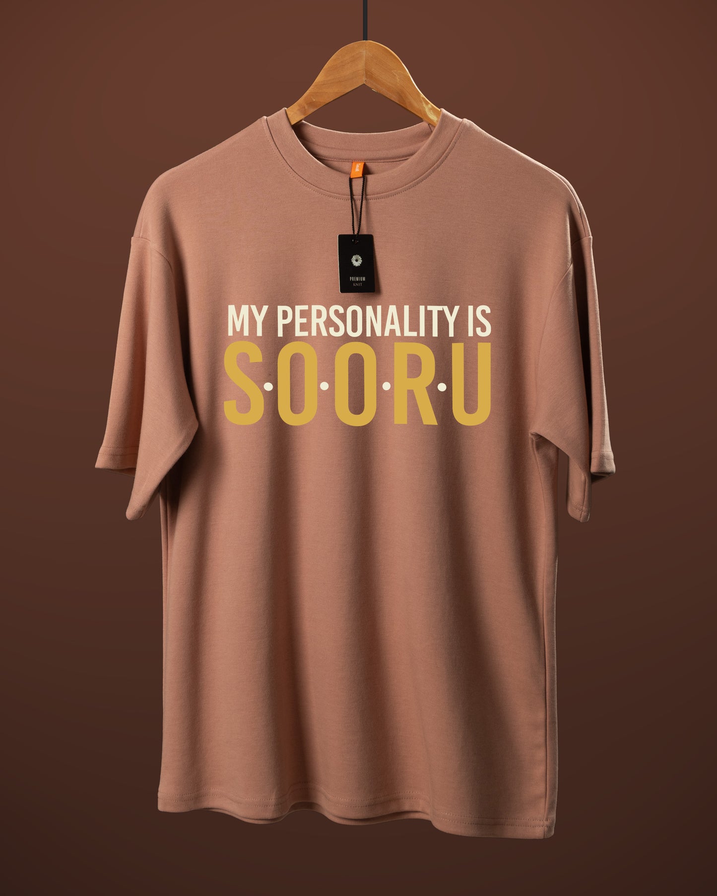 DUMM My Personality Is Sooru oversized t-shirt in dusty rose on wooden hanger