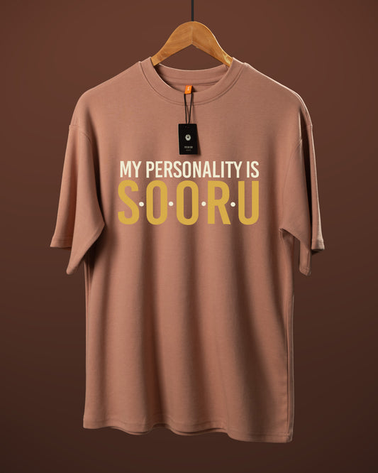 DUMM My Personality Is Sooru oversized t-shirt in dusty rose on wooden hanger