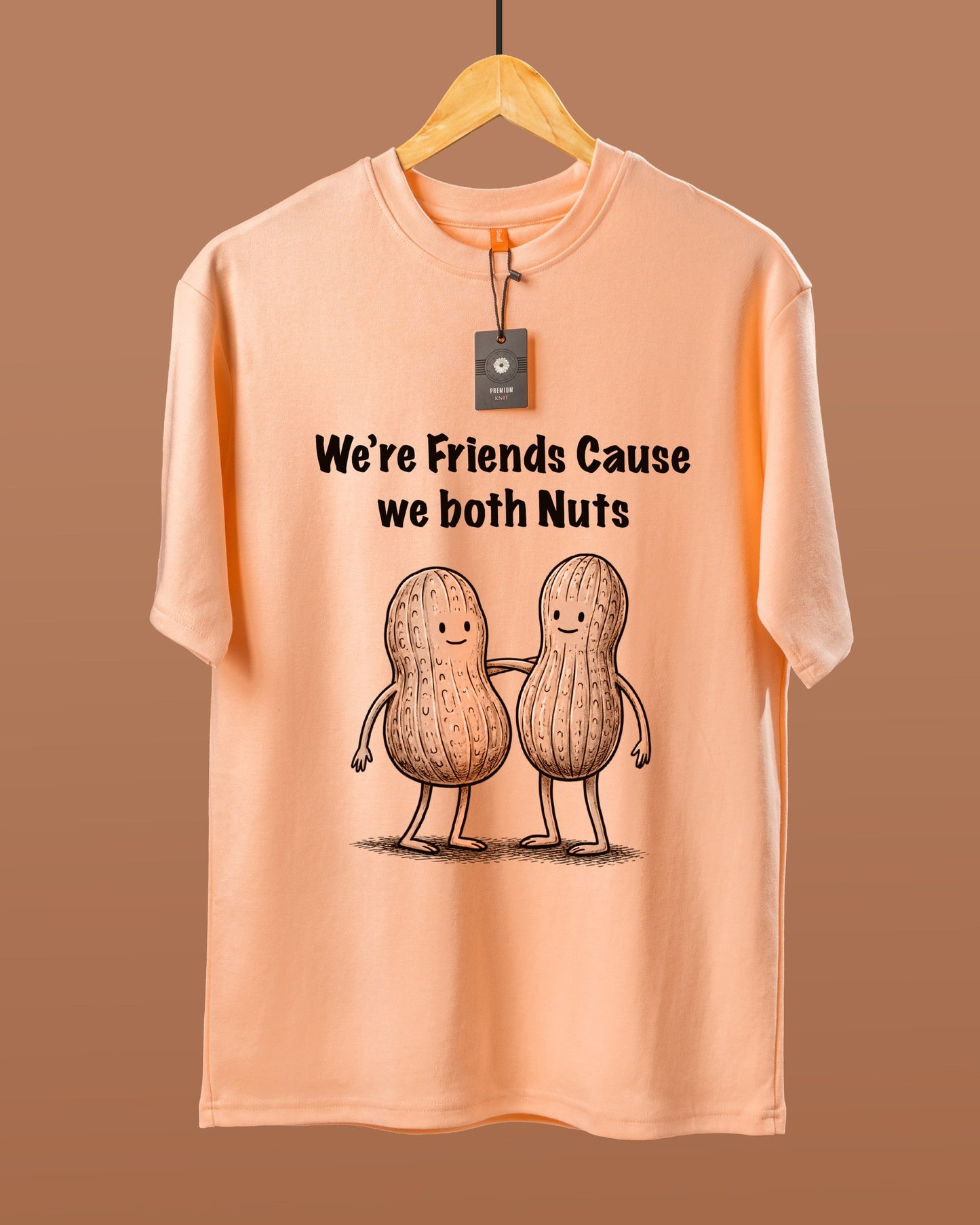 DUMM We're Friends Cause We Both Nuts oversized t-shirt in peach on wooden hanger