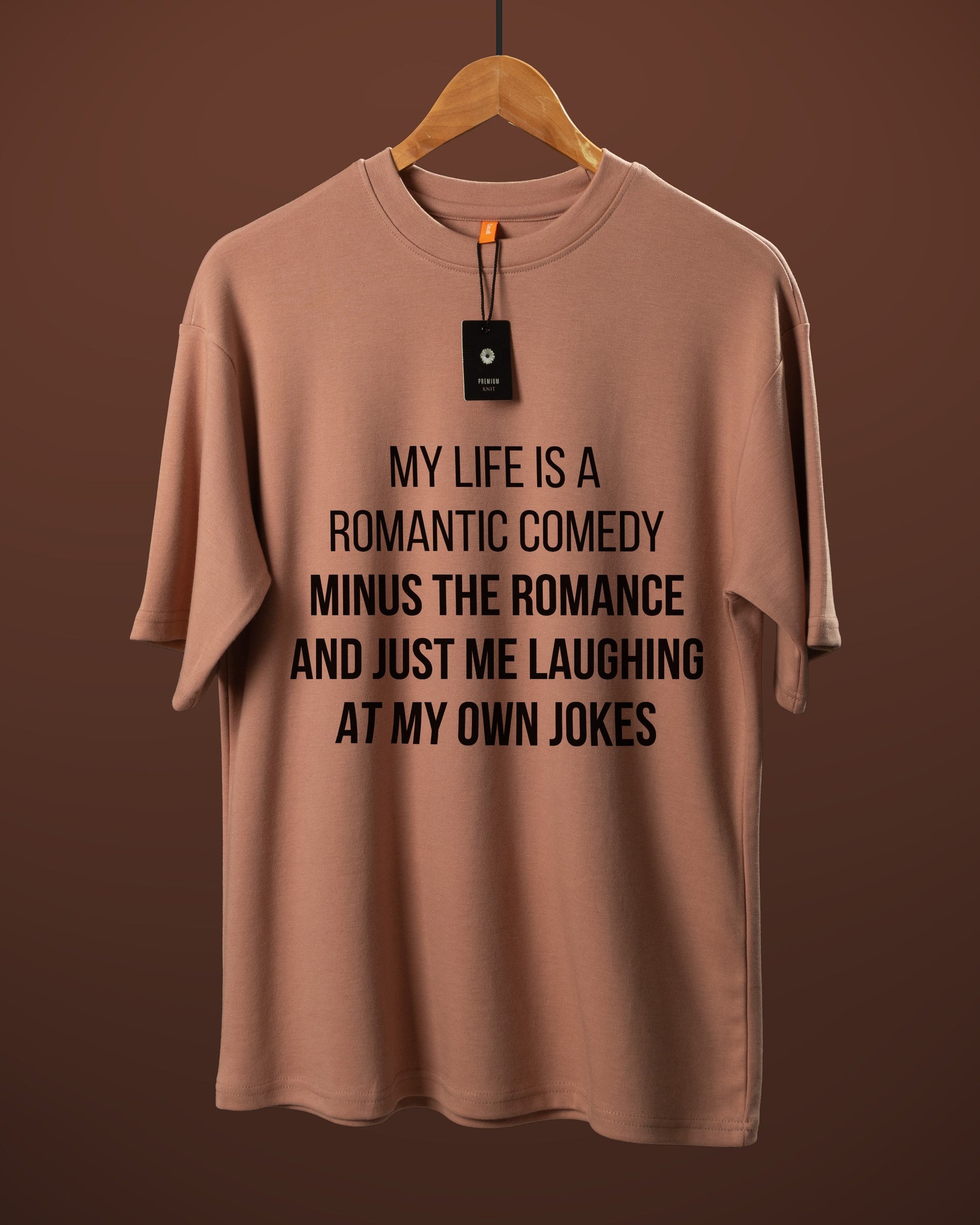 DUMM Romantic Comedy Minus The Romance oversized t-shirt in dusty rose on wooden hanger
