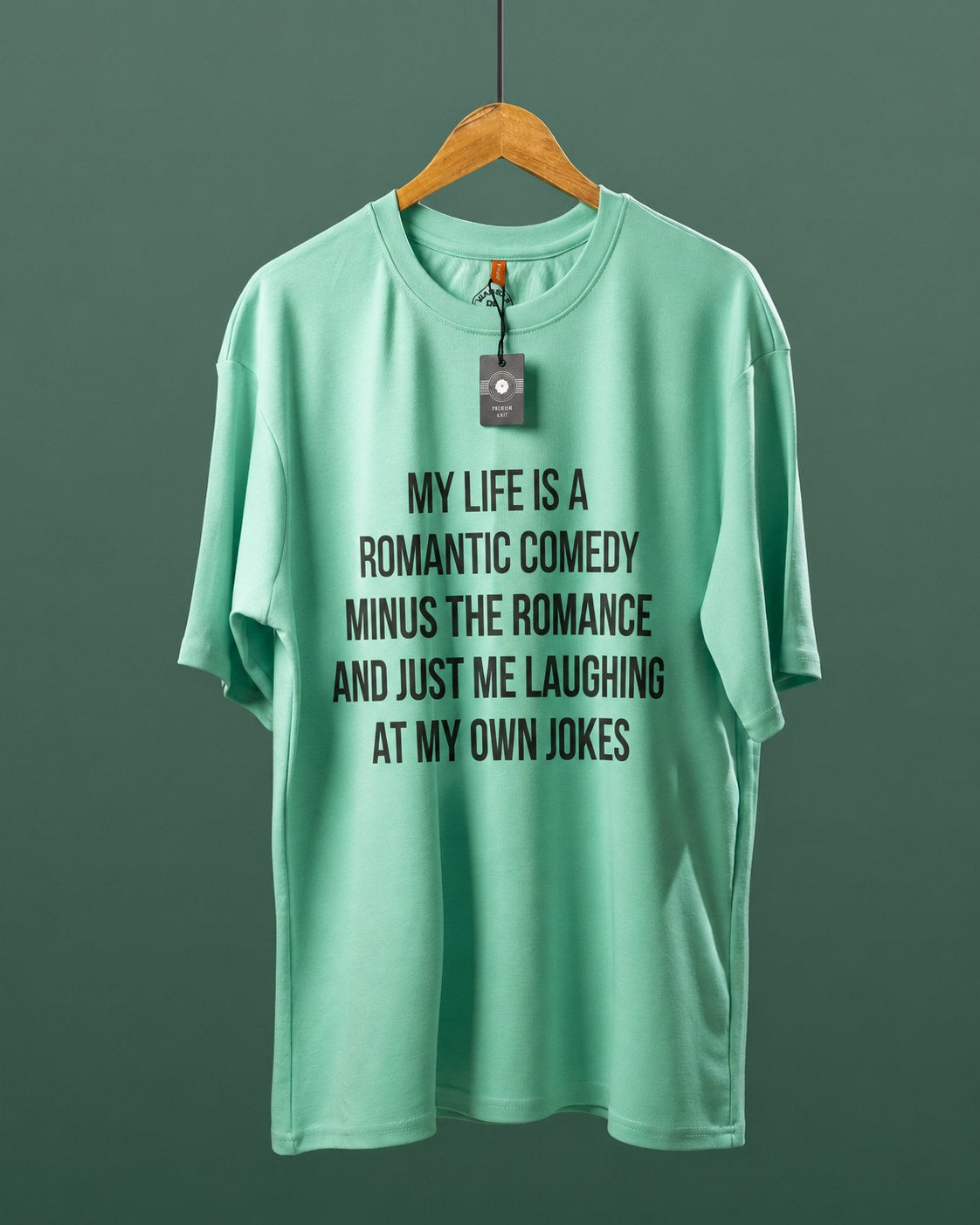 DUMM Romantic Comedy Minus The Romance oversized t-shirt in mint green on wooden hanger