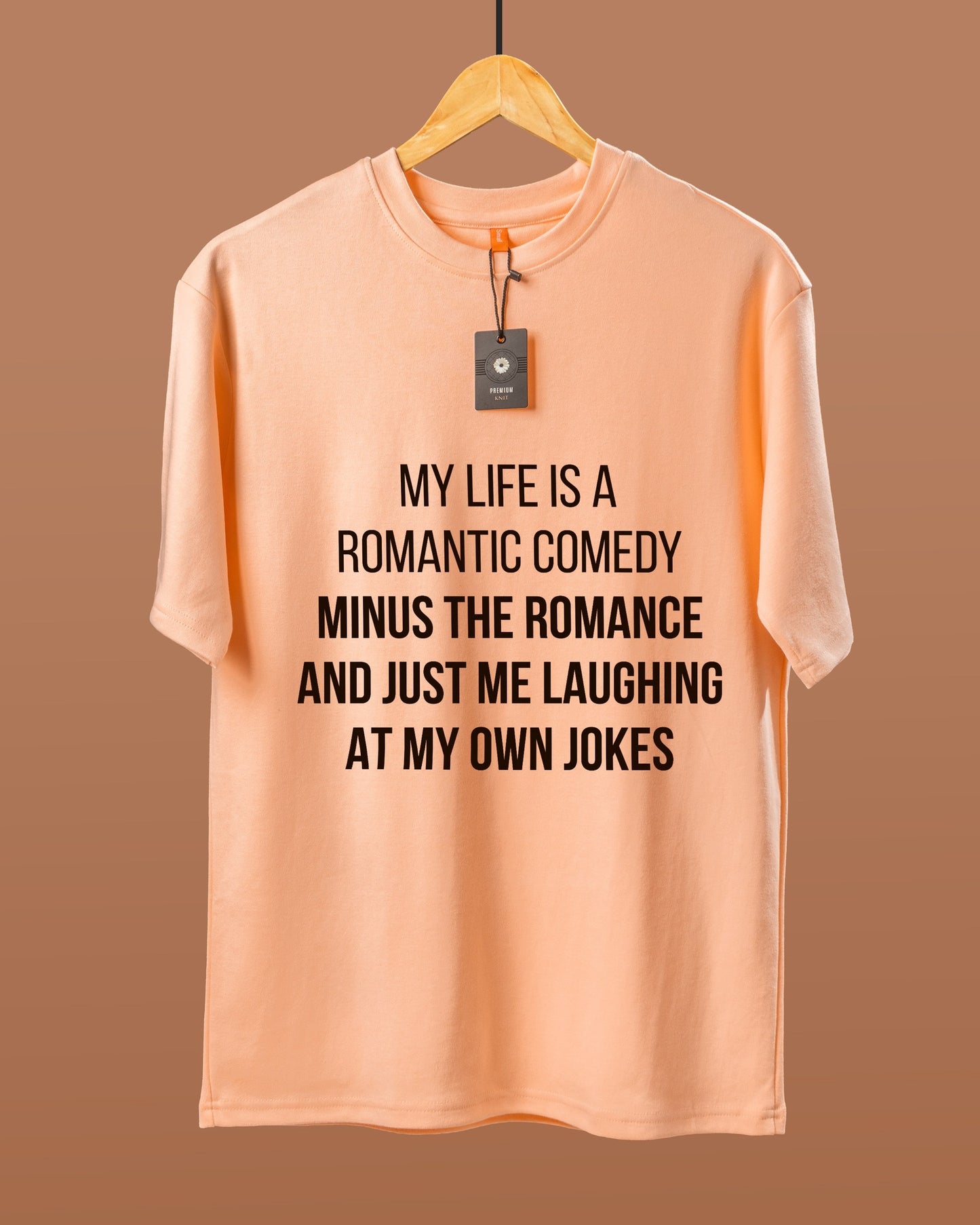 DUMM Romantic Comedy Minus The Romance oversized t-shirt in peach on wooden hanger